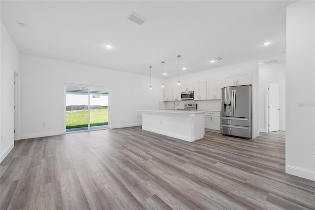 6257 SW 153 Rd Ln, Ocala, FL 34473 - kitchen featuring light wood finished floors, visible vents, baseboards, appliances with stainless steel finishes, and white cabinetry