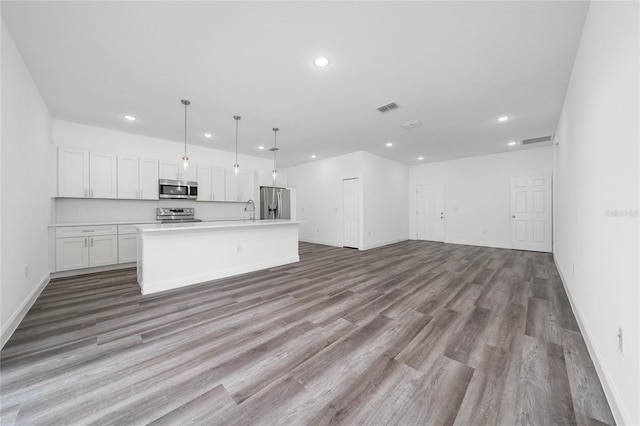 6257 SW 153 Rd Ln, Ocala, FL 34473 - kitchen featuring white cabinets, stainless steel appliances, open floor plan, and recessed lighting