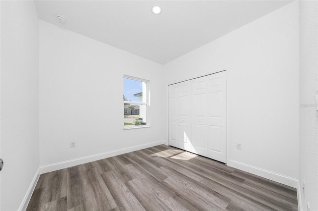 6257 SW 153 Rd Ln, Ocala, FL 34473 - unfurnished bedroom with wood finished floors, a closet, and baseboards