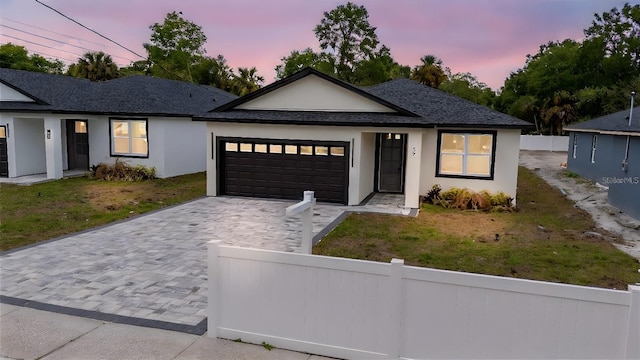 59 W 10th St, Apopka, FL 32703 - ranch-style house featuring an attached garage, decorative driveway, stucco siding, and a shingled roof