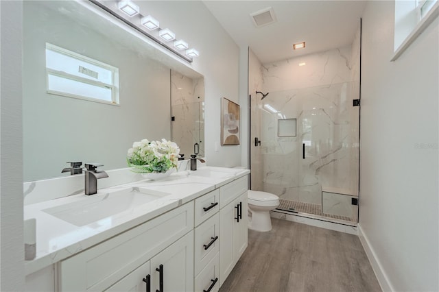 59 W 10th St, Apopka, FL 32703 - bathroom with a marble finish shower, wood finished floors, and double vanity