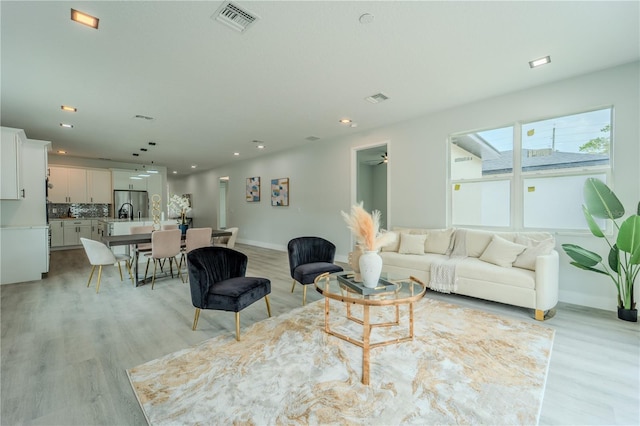 59 W 10th St, Apopka, FL 32703 - living area featuring light wood-style floors and recessed lighting