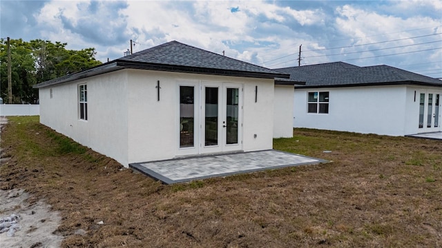 59 W 10th St, Apopka, FL 32703 - rear view of property featuring french doors, stucco siding, a lawn, and a shingled roof