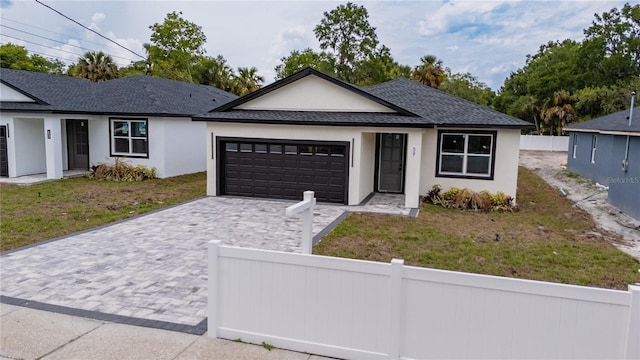 59 W 10th St, Apopka, FL 32703 - ranch-style house with a fenced front yard, a garage, decorative driveway, and stucco siding
