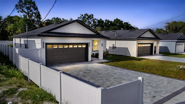59 W 10th St, Apopka, FL 32703 - ranch-style home with driveway, an attached garage, and stucco siding