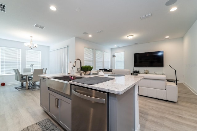 kitchen featuring dishwasher, gray cabinets, light wood-style flooring, baseboards, and visible vents