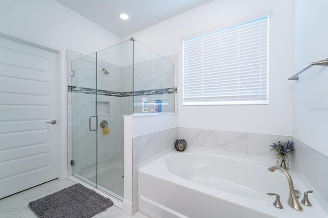 bathroom featuring a shower stall and a garden tub