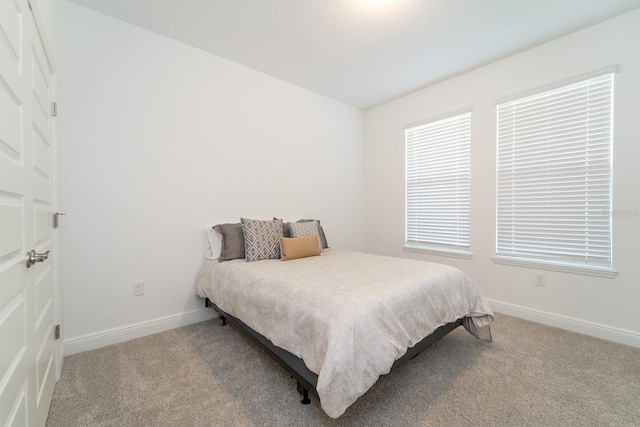 carpeted bedroom with baseboards