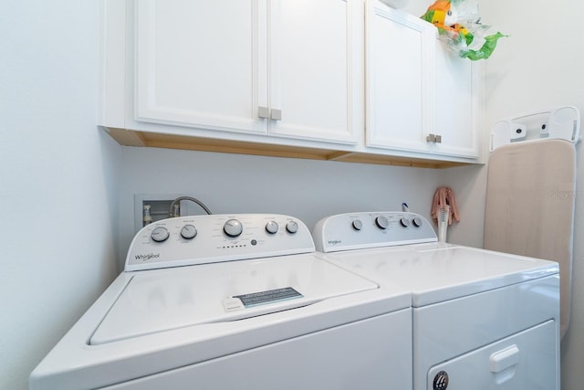 laundry area with washer and dryer and cabinet space