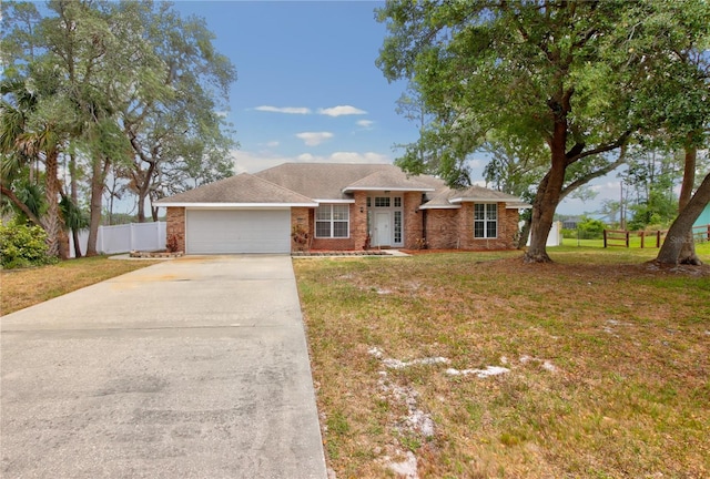 ranch-style house featuring a front lawn, driveway, fence, and a garage