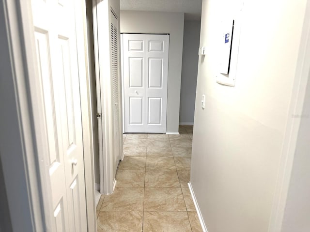 604 Kenwick Cir Unit 105, Casselberry, FL 32707 - corridor featuring baseboards and light tile patterned flooring