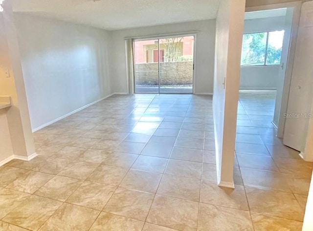 604 Kenwick Cir Unit 105, Casselberry, FL 32707 - empty room featuring baseboards and light tile patterned floors