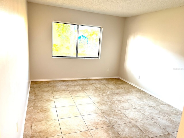 604 Kenwick Cir Unit 105, Casselberry, FL 32707 - empty room with light tile patterned flooring and a textured ceiling