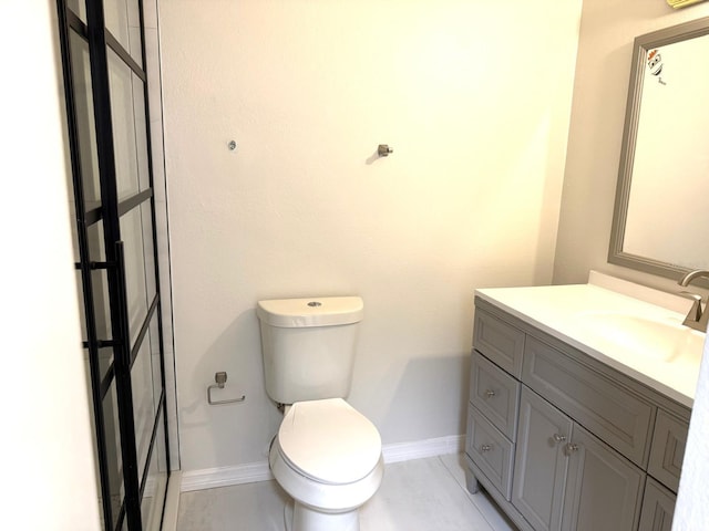 604 Kenwick Cir Unit 105, Casselberry, FL 32707 - bathroom with baseboards, toilet, and vanity