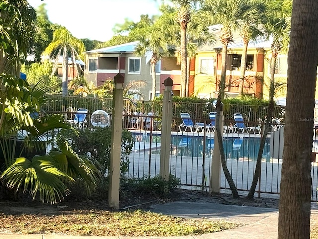 604 Kenwick Cir Unit 105, Casselberry, FL 32707 - view of gate with fence and a community pool