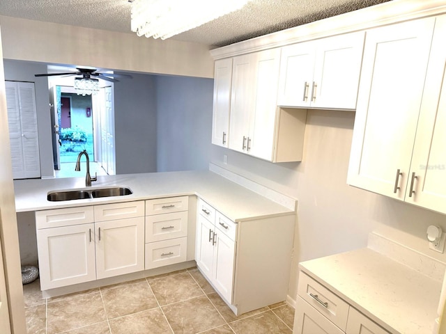 604 Kenwick Cir Unit 105, Casselberry, FL 32707 - kitchen featuring a ceiling fan, white cabinetry, a textured ceiling, and light tile patterned floors