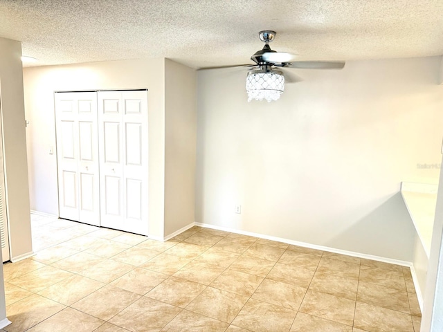 604 Kenwick Cir Unit 105, Casselberry, FL 32707 - unfurnished dining area featuring a ceiling fan, a textured ceiling, and light tile patterned floors