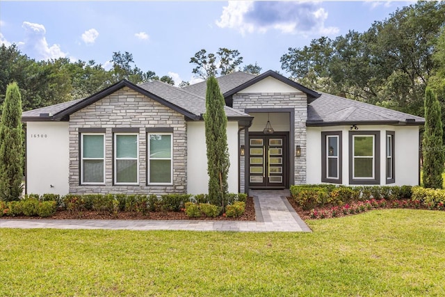16500 Magnolia Terrace Blvd, Montverde, FL 34756 - view of front of home with stone siding, a front yard, and stucco siding