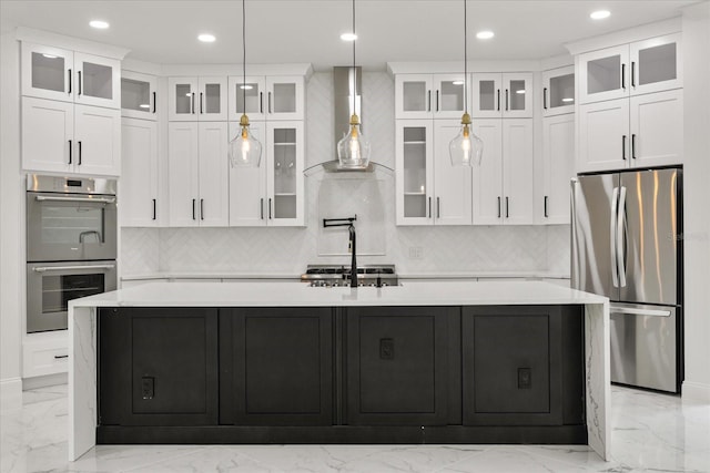 16500 Magnolia Terrace Blvd, Montverde, FL 34756 - kitchen featuring appliances with stainless steel finishes, wall chimney exhaust hood, a large island with sink, light marble finish floors, and recessed lighting