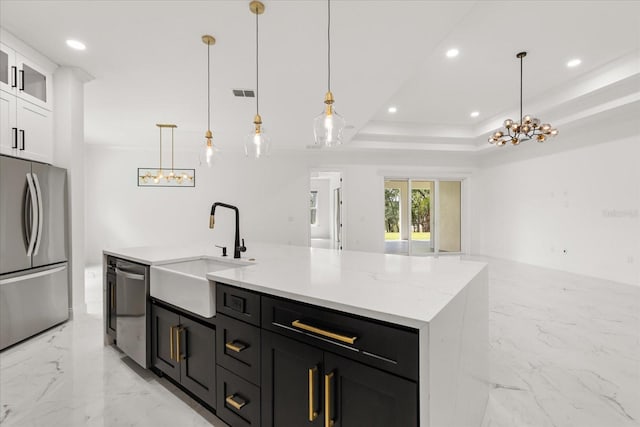 16500 Magnolia Terrace Blvd, Montverde, FL 34756 - kitchen with stainless steel appliances, a sink, light marble finish floors, white cabinets, and open floor plan