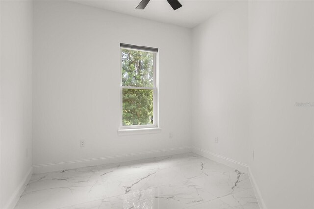 16500 Magnolia Terrace Blvd, Montverde, FL 34756 - spare room featuring light marble finish floors, ceiling fan, and baseboards