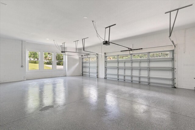 16500 Magnolia Terrace Blvd, Montverde, FL 34756 - garage with a garage door opener and concrete block wall
