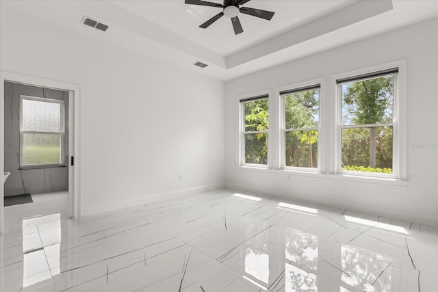 16500 Magnolia Terrace Blvd, Montverde, FL 34756 - unfurnished room with a ceiling fan, baseboards, marble finish floors, and a tray ceiling
