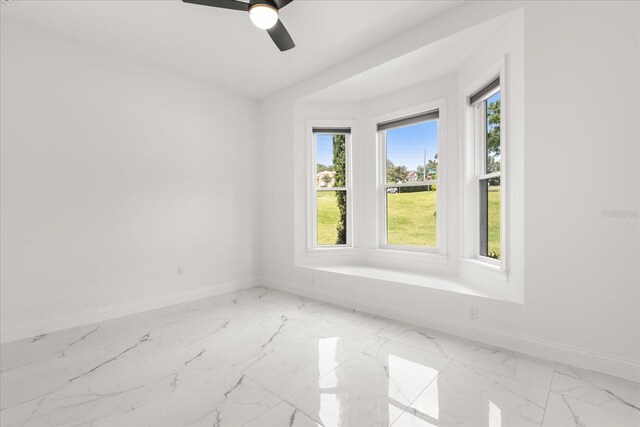 16500 Magnolia Terrace Blvd, Montverde, FL 34756 - spare room featuring baseboards, light marble finish floors, and a ceiling fan