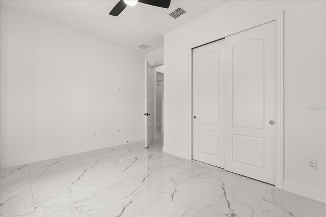 16500 Magnolia Terrace Blvd, Montverde, FL 34756 - unfurnished bedroom featuring light marble finish flooring, baseboards, a closet, and ceiling fan