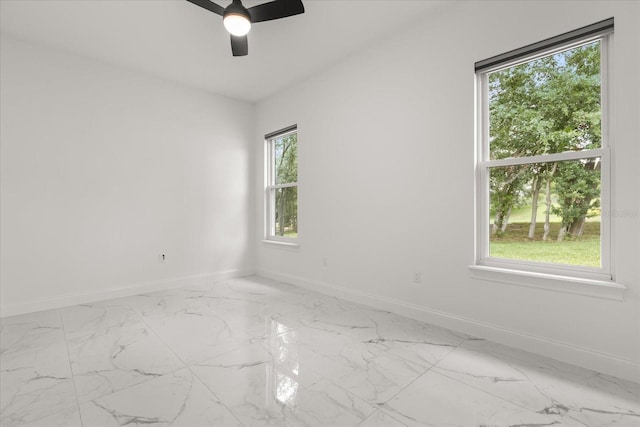 16500 Magnolia Terrace Blvd, Montverde, FL 34756 - unfurnished room with baseboards, light marble finish flooring, and a ceiling fan