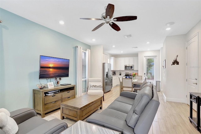 8044 Lost Shaker Ln, Kissimmee, FL 34747 - living area featuring a ceiling fan, beverage cooler, baseboards, and recessed lighting