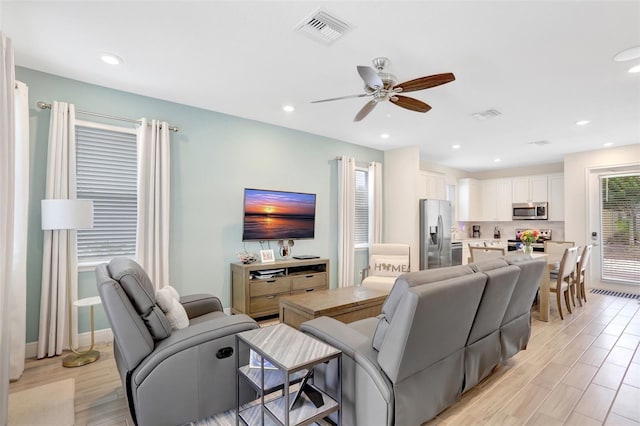 8044 Lost Shaker Ln, Kissimmee, FL 34747 - living area featuring a ceiling fan, light wood-style flooring, and recessed lighting