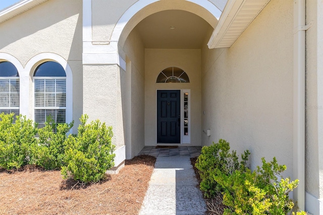 property entrance featuring stucco siding