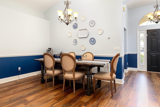 dining room with baseboards, an inviting chandelier, and wood finished floors
