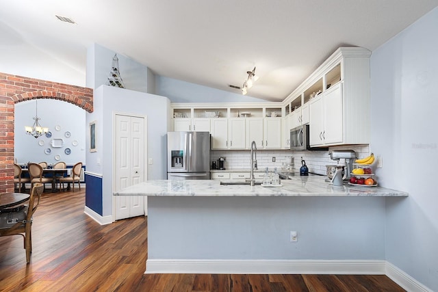 kitchen featuring visible vents, open shelves, vaulted ceiling, a peninsula, and stainless steel appliances