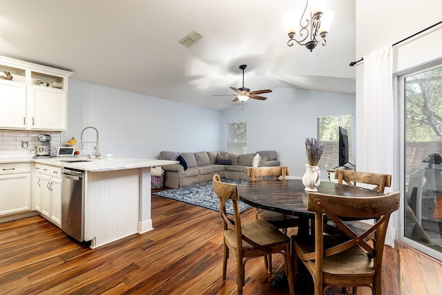 dining area with ceiling fan, visible vents, vaulted ceiling, and dark wood-type flooring