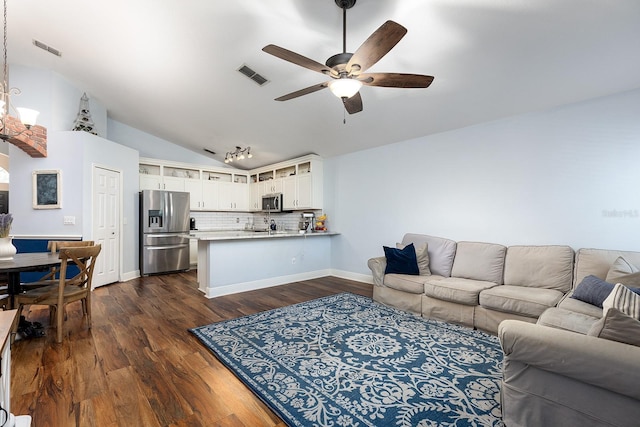 living room with a ceiling fan, visible vents, lofted ceiling, and dark wood-type flooring