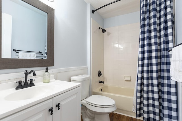 full bath with vanity, shower / bath combo with shower curtain, wainscoting, wood finished floors, and toilet