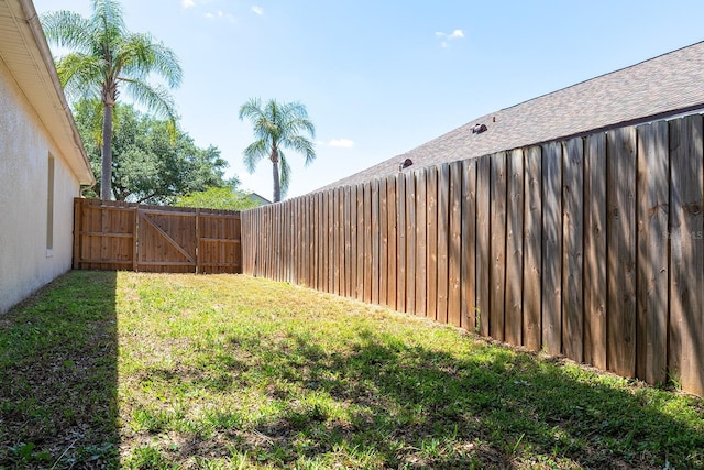 view of yard with fence and a gate