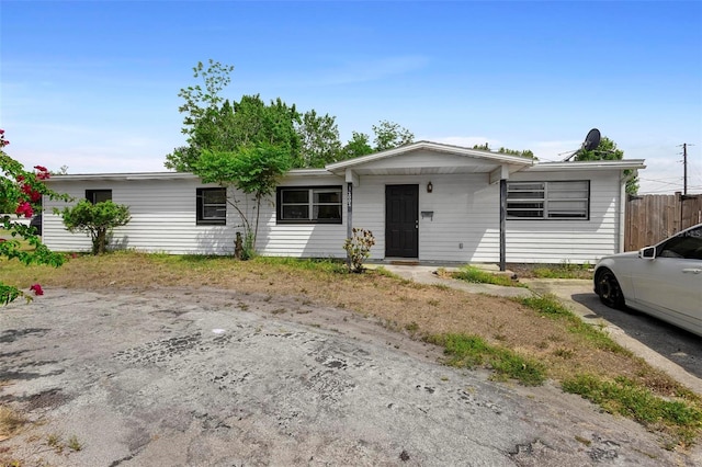 ranch-style house with fence