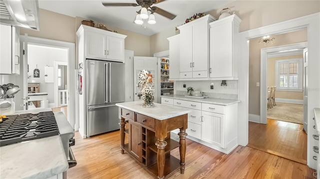 kitchen featuring white cabinetry, light countertops, a ceiling fan, and appliances with stainless steel finishes