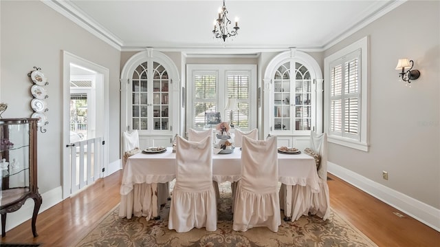 sunroom / solarium featuring an inviting chandelier and french doors