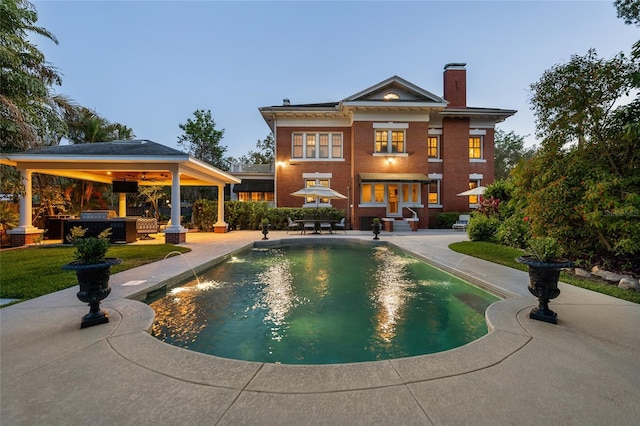 outdoor pool with a gazebo and a patio