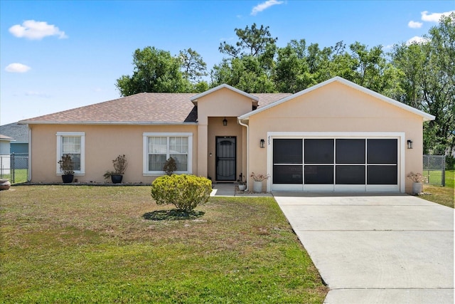 single story home featuring a front yard, driveway, an attached garage, and fence