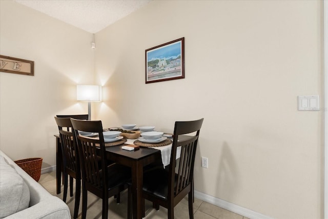 dining room with light tile patterned flooring and baseboards