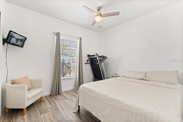 bedroom featuring a ceiling fan and baseboards