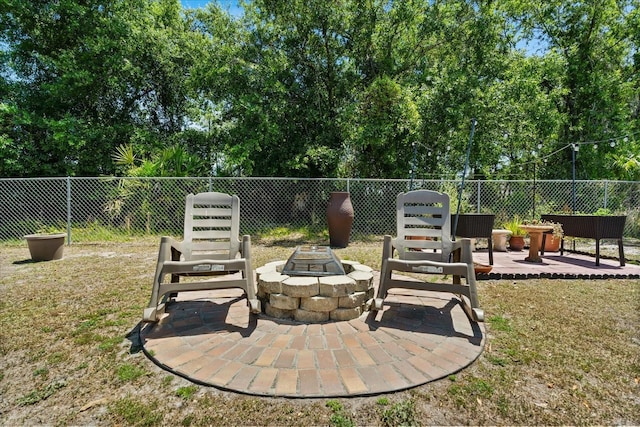 view of patio / terrace featuring fence and an outdoor fire pit