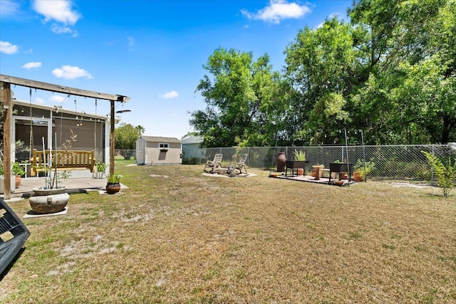 view of yard with an outbuilding, a storage shed, fence private yard, and a sunroom