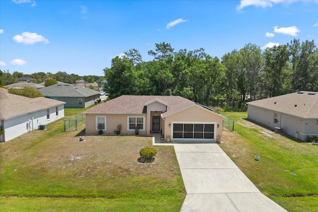 single story home featuring stucco siding, fence, driveway, a front yard, and an attached garage