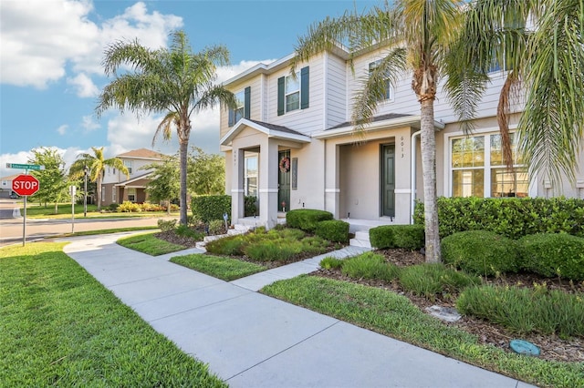 6013 Blue Lily Way, Winter Garden, FL 34787 - traditional home featuring stucco siding and a front lawn